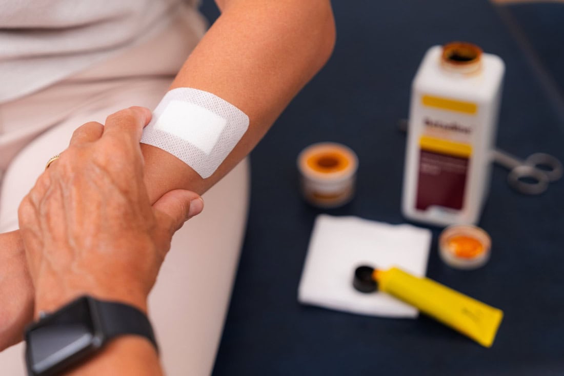 A person receives wound care after a surgical procedure at the GP's office.