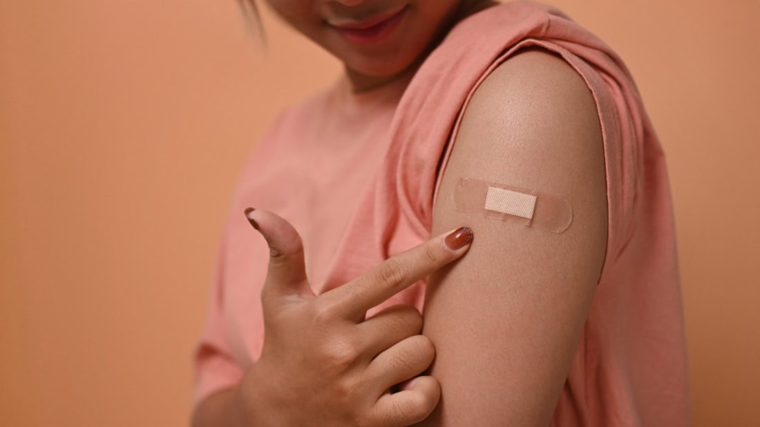 Disease vaccination shot on arm for travel and healthcare, show vaccination certificate.