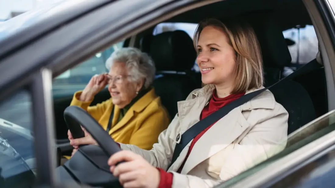 Woman drives an elderly lady in her car